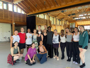 A group of 17 people in the Perles family studio at Jacob's Pillow