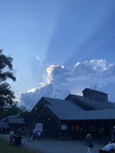 The early evening sun breaks through the clouds in front of the Ted Shawn Theatre at Jacob's Pillow. 